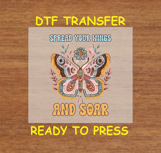 "DTF transfer featuring a colorful butterfly surrounded by flowers with the phrase 'Spread Your Wings and Soar' in retro-style lettering."