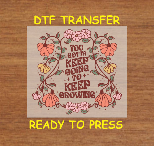 "You Gotta Keep Growing DTF transfer with retro floral accents, ready to press."