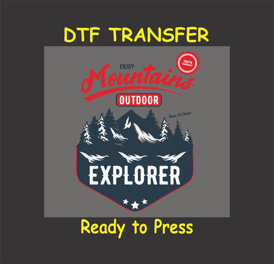 "DTF transfer with mountain scene, trees, and text 'Mountain Explorer' and 'Born to Climb,' ready to press for outdoor apparel."