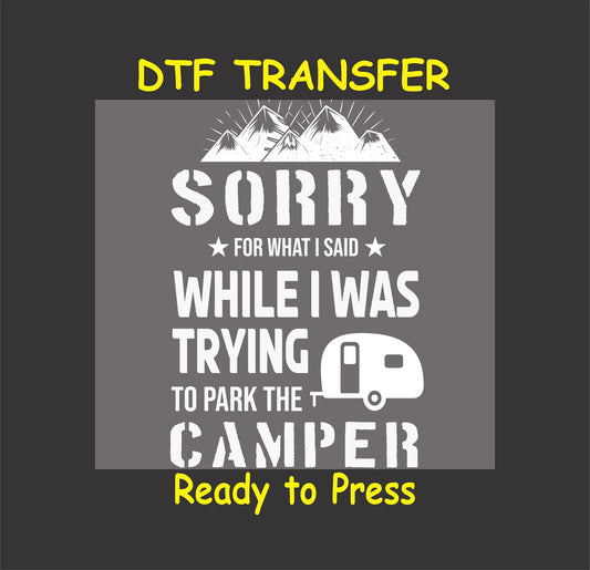 "Funny DTF transfer with 'Sorry For What I Said While Parking the Camper,' mountain graphic, and camper icon, ready to press."