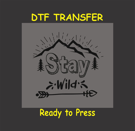 "Stay Wild DTF transfer with mountain range, trees, and arrow design, ready to press for custom nature-themed shirts."