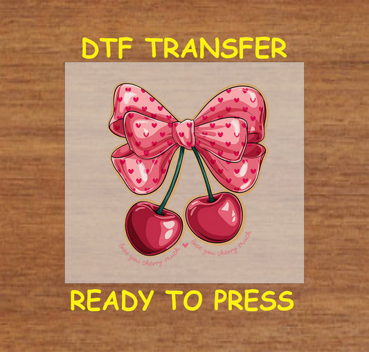 DTF transfer featuring two glossy cherries tied with a pink bow adorned with heart patterns, and the phrase "Love You Cherry Much" below.