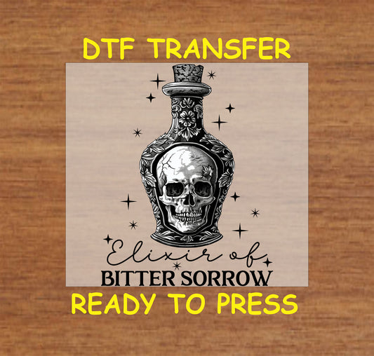 Gothic potion bottle with a skull inside and celestial details, "Elixir of Bitter Sorrow" text, DTF transfer.