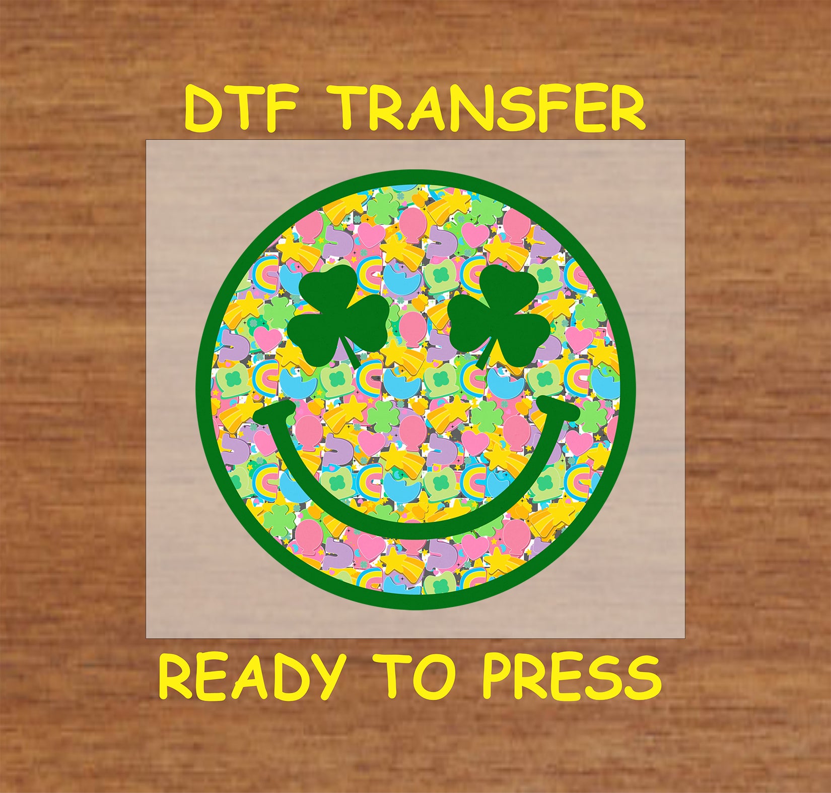 St. Patrick’s Day kids DTF transfer with a clover-eyed smiley face filled with colorful shamrocks, rainbows, hearts, and stars.