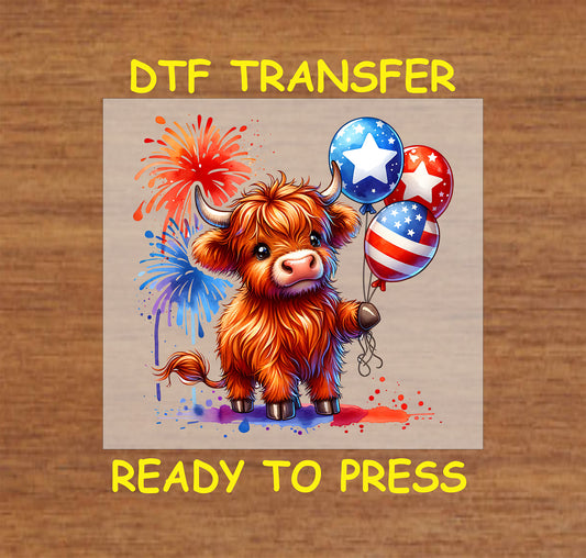 Highland cow holding patriotic balloons with fireworks in the background.