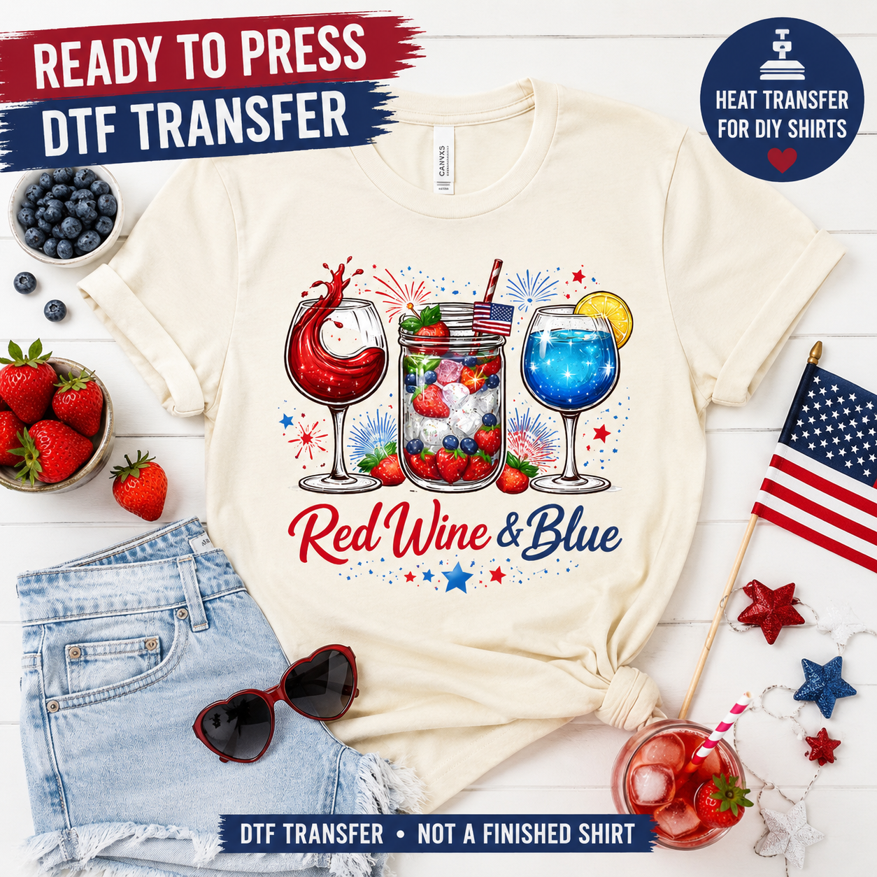 White t-shirt with 'Red Wine & Blue' design, surrounded by berries, sunglasses, and an American flag on a white background.
