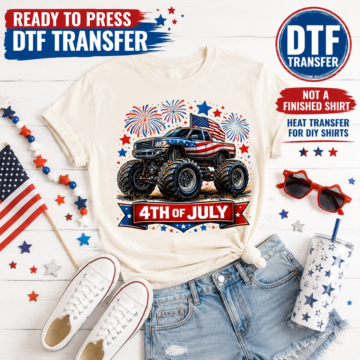 White t-shirt with 4th of July design featuring a monster truck, American flag, and fireworks, surrounded by accessories on a white background.