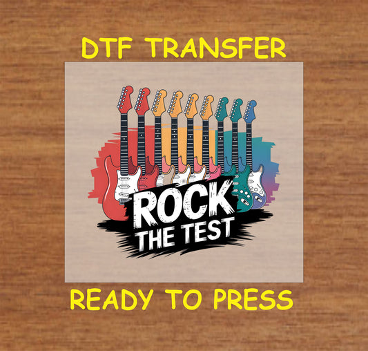 Rock the Test DTF transfer with colorful guitars and bold text.