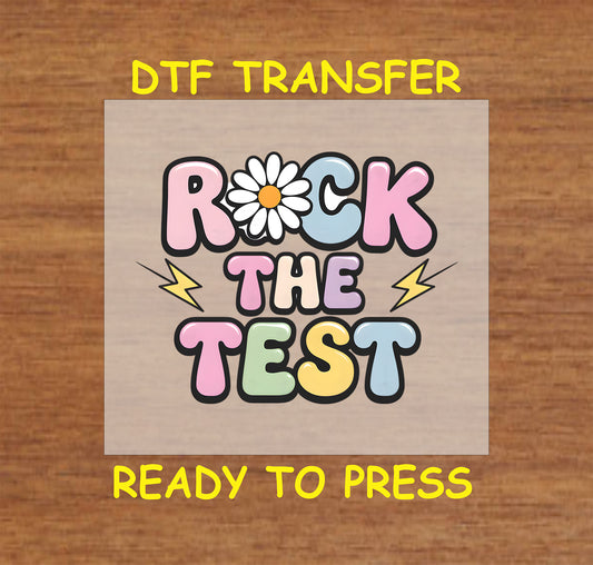 Rock the Test DTF transfer with colorful guitars and bold lettering.