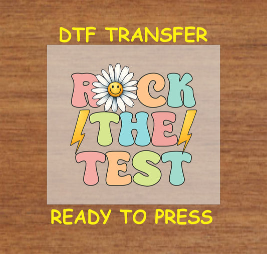 Rock the Test DTF transfer with pastel retro font, smiley daisy, and lightning bolts.