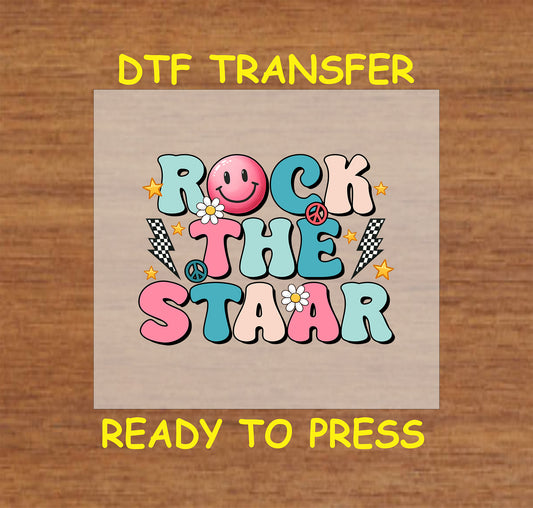 Rock the STAAR DTF transfer with groovy retro-style letters, a smiley face, and peace signs.
