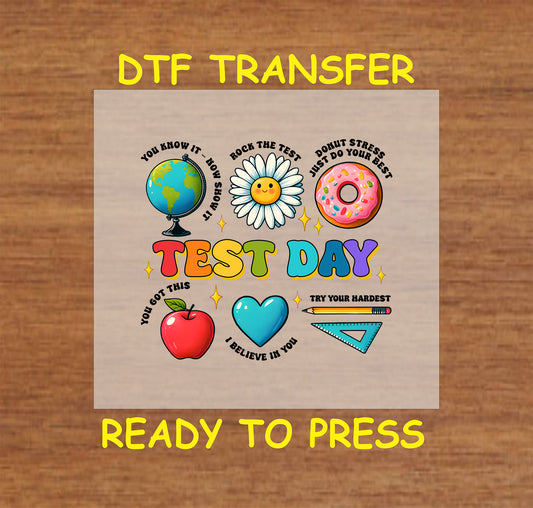 Test Day DTF transfer with a globe, donut, daisy, apple, heart, and motivational phrases.