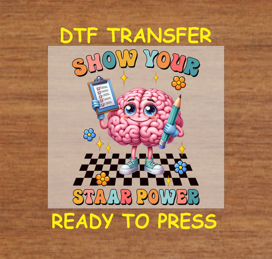 Show Your STAAR Power DTF transfer with a cartoon brain, clipboard, pencil, and checkered background.