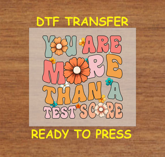 You Are More Than a Test Score DTF transfer with retro bubble letters and floral accents.