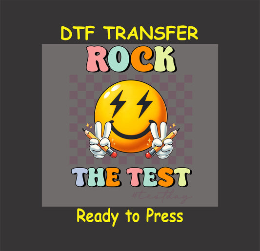 Rock the Test DTF transfer with a lightning-eyed smiley face, peace signs, pencils, and a checkered background.