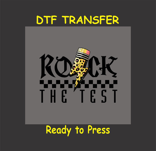 Rock the Test DTF transfer with gothic text, a leopard print pencil, lightning bolt, and checkered pattern.