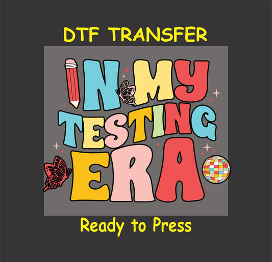In My Testing Era DTF transfer with bold text, a pencil, butterflies, and a disco ball.