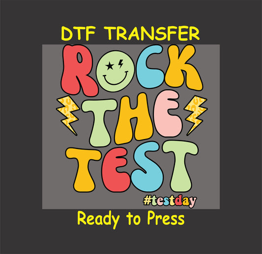 Rock the Test DTF transfer with retro colorful text, smiley face, and lightning bolts.