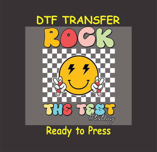 Rock the Test DTF transfer with retro colorful text, smiley face, and lightning bolts.