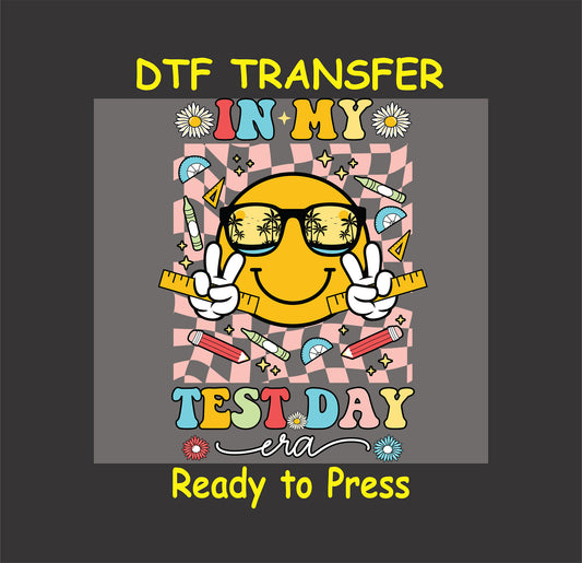 In My Test Day Era DTF transfer with a retro smiley face, sunglasses, school supplies, and checkered background.