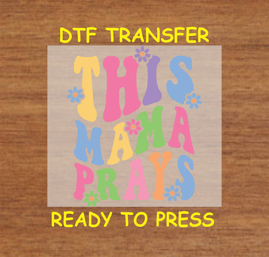 This Mama Prays DTF transfer with colorful retro letters and floral accents.