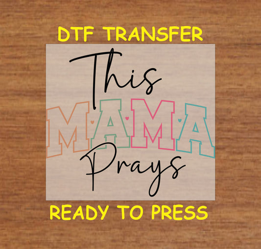 This Mama Prays DTF transfer with script text and pastel block letters.