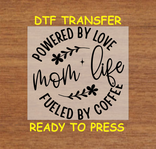 Mom Life DTF transfer with circular floral design and text reading "Powered by Love, Fueled by Coffee."