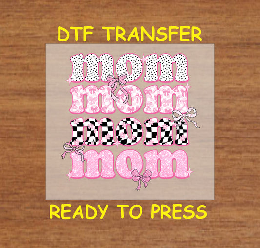 Mom DTF transfer with pink, checkered, and polka dot text, decorated with bows.