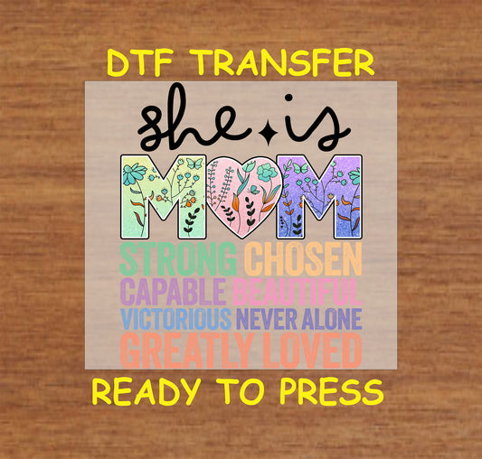 “She is Mom” DTF transfer with floral "MOM" letters and encouraging words in colorful text.
