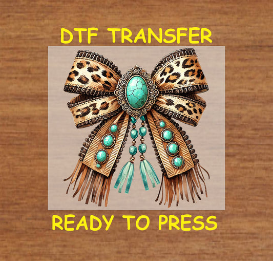 Leopard print bow with turquoise stones, beaded details, and fringe accents.