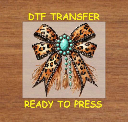 Leopard print bow with turquoise stones, beaded details, and fringe accents.