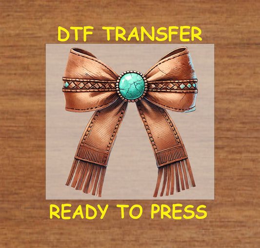 Leather-textured bow with a turquoise gemstone and fringe accents.