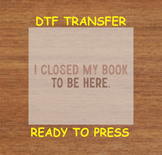 Brown distressed text reading "I Closed My Book To Be Here."