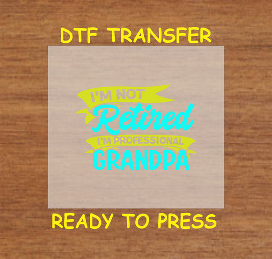 Not Retired Grandpa DTF transfer with blue and yellow text on a neutral background.