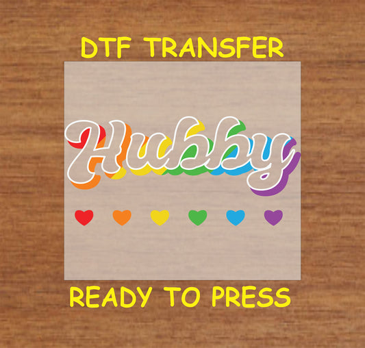 Hubby DTF transfer with rainbow-accented script font and colorful hearts.