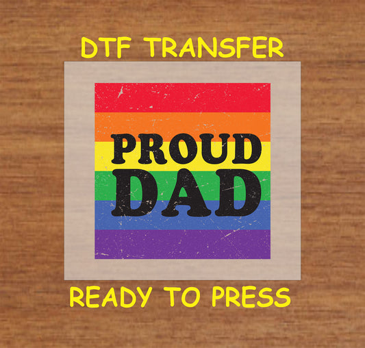 Proud Dad DTF transfer with bold black text over a distressed rainbow background.