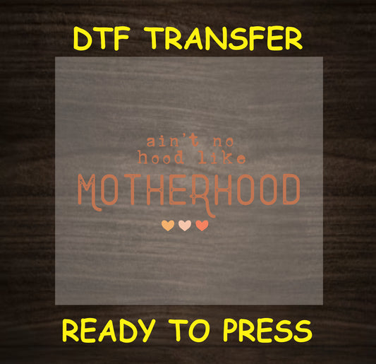"Ain’t No Hood Like Motherhood" design in warm orange tones with heart accents.