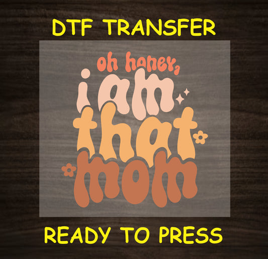 "Oh Honey, I Am That Mom" design with a retro-inspired font and flower accents.