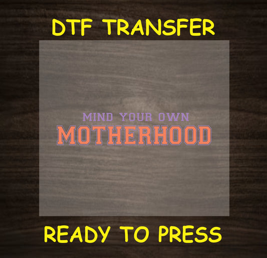"Mind Your Own Motherhood" DTF transfer with bold typography, perfect for a fun, empowering mom shirt.