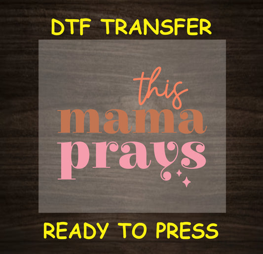 "This Mama Prays" DTF transfer design featuring elegant text in pink and earthy orange, perfect for custom mom apparel.
