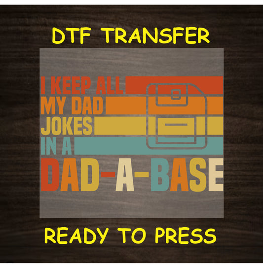 Retro text reading “I Keep All My Dad Jokes in a Dad-A-Base” with a briefcase icon in orange, yellow, teal.