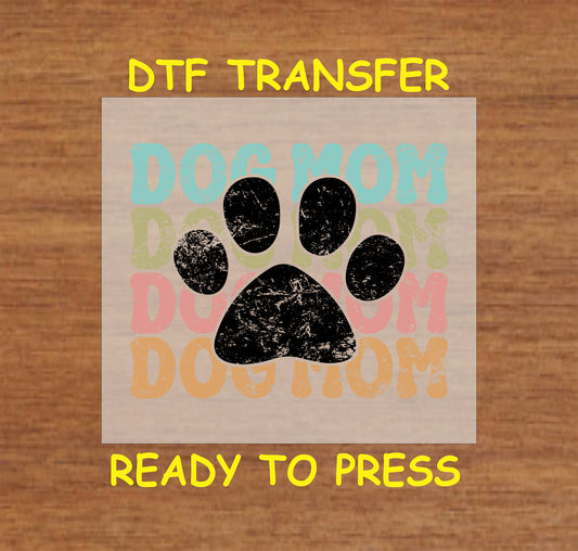 Retro DTF transfer with large distressed black paw print and multicolor background text.