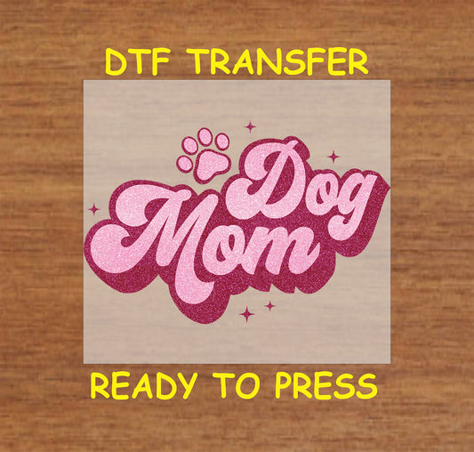 Sparkly pink DTF transfer with large script lettering and a paw print.
