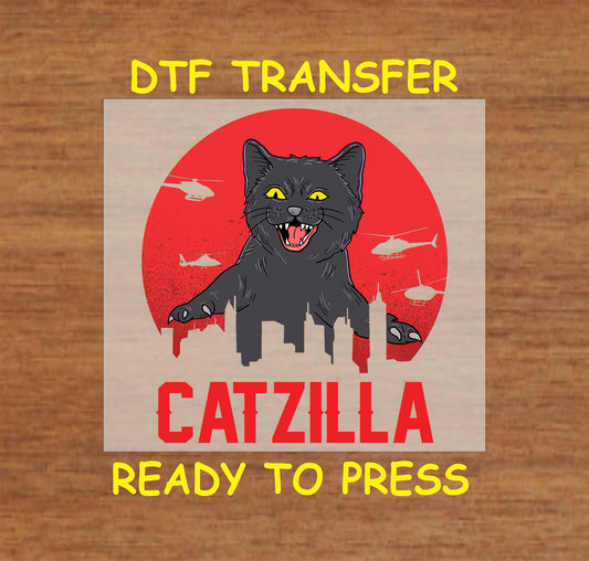 DTF transfer with black cat towering over city skyline and red sun background, labeled “Catzilla”