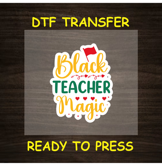 DTF transfer with “Black Teacher Magic” in red, yellow, and green text with hearts and flag.