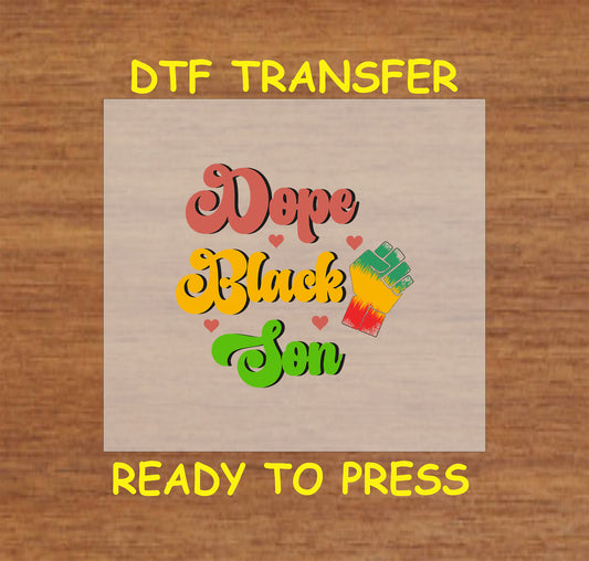Dope Black Son text with red, yellow, green colors, hearts, and a raised fist on wood background.