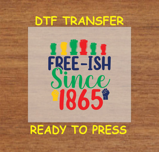 Free-ish Since 1865 text with red, yellow, green, and navy fists on wood background
