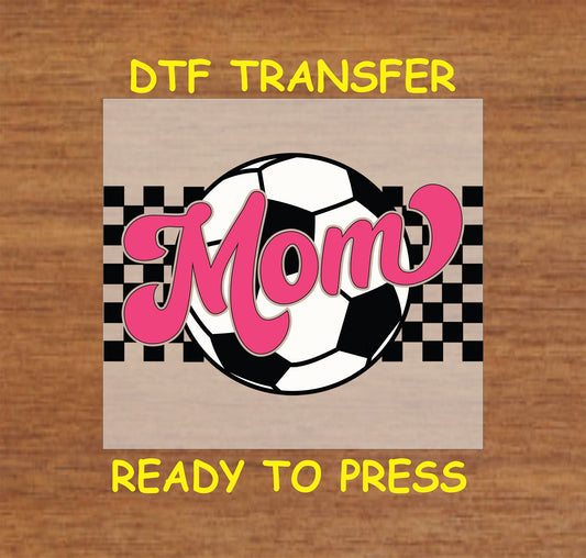 Pink mom text over soccer ball with checker background DTF transfer.