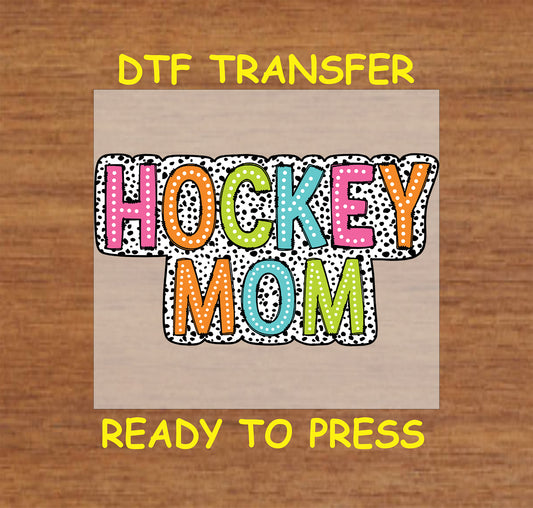 Colorful Hockey Mom DTF transfer with polka dot background and bold block lettering.