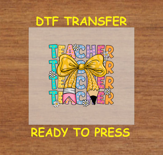 Colorful stacked Teacher DTF transfer with pencil, yellow bow, and flower accents.